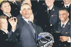  ??  ?? Obama holds a ring as he welcomes the US Naval Academy Football Team to present them with the 2015 Commander-in-Chief’s Trophy at the White House in Washington DC, US. — Reuters photo