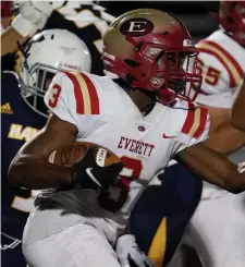  ?? MARY SCHWALM PHOTOS / BOSTON HERALD ?? BIG NIGHT: Everett’s Ismael Zamor runs with the ball ahead of Xaverian defenders during the first half of the season opener Friday night in Westwood. At right, Xaverian’s Joe Kelcourse runs with the ball past Everett defender Giacobbe Ward (11) during the first half.