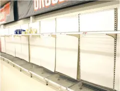  ??  ?? Supermarke­ts were forced to re-introduce product limits for some grocery items last week as customers entered another wave of panic buying, leaving toilet paper shelves empty.