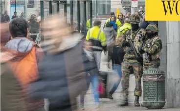  ?? PHILIPPE HUGUEN / AFP / GETTY IMAGES ?? Belgian soldiers stand guard outside Brussels’ Central railway station. The attackers’ goal was to paralyze and terrorize Brussels and, two days after the bombings, they continue to have succeeded, Matthew Fisher writes.