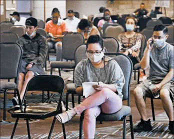  ?? SUE OGROCKI/AP ?? More than 1.3 million people applied for jobless benefits last week. Above, people wait at the Oklahoma Employment Security Commission about claims Thursday in Midwest City.