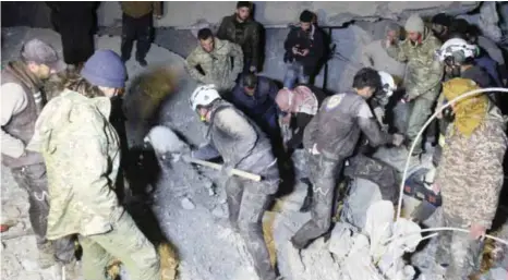  ??  ?? AL-JINEH, Syria: Syrian civil defense volunteers, known as the White Helmets, dig through the rubble of a mosque following a reported airstrike in this village in Aleppo province late Thursday. — AFP