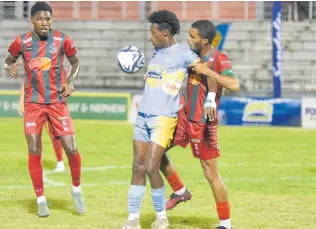  ?? ASHLEY ANGUIN/PHOTOGRAPH­ER ?? Waterhouse FC’s Javane Bryan (centre) tries to bring a ball under control while staving off the attention of Montego Bay United’s Renaldo Wellington during their Wray and Nephew/Jamaica Premier League football match at the Montego Bay Sports Complex in Montego Bay on Monday.