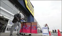  ?? MARK MORAN/THE CITIZENS’ VOICE VIA AP ?? Shoppers leave a Best Buy store on Black Friday, in Wilkes-Barre, Pa., Nov. 27, 2020.