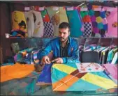  ?? WAKIL KOHSAR / AFP ?? An Afghan kite vendor cuts tissue paper as he makes a kite in a shop in Shor Bazaar in Kabul, on April 16.