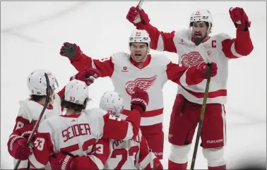  ?? CHRISTINNE MUSCHI — THE CANADIAN PRESS VIA AP ?? Detroit’s Moritz Seider celebrates with teammates after his goal against the Canadiens during the first period on Tuesday in Montreal.