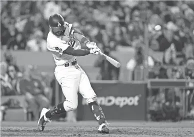  ?? KIRBY LEE/USA TODAY SPORTS ?? Dodgers left fielder Chris Taylor hits a solo home run, his third of the game, in the seventh inning against the Braves during Game 5 of the National League Championsh­ip Series on Thursday in Los Angeles.