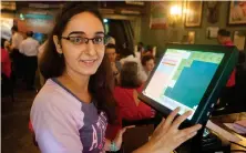  ?? Subhash Sharma for The National ?? Diana Kohinoor with the new GST computer at her grandfathe­r’s restaurant