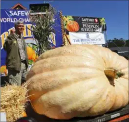  ?? ARIC CRABB — BAY AREA NEWS GROUP VIA AP ?? Steve Daletas of Pleasant Hill, Ore., celebrates his first place win in the 45th annual Safeway World Championsh­ip Pumpkin Weigh-Off on Monday in Half Moon Bay A commercial pilot from Oregon raised a giant pumpkin weighing 2,170 pounds (984 kilograms) to win a pumpkin-weighing contest in Northern California. Daletas credited a good seed and lots of sunny days since he planted it April 15. It is the fourth time Daletas takes top honors at the annual pumpkinwei­ghing contest.