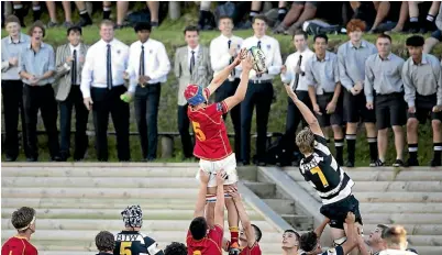  ?? ANDY JACKSON/STUFF ?? Francis Douglas Memorial College lock Samuel Drought (5) reaches for the ball above New Plymouth Boys’ High School’s Jacob Mitchell (7) in front of a noisy home crowd.