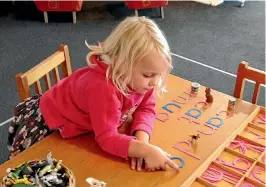  ?? PHOTOS: SUPPLIED ?? Jean Clark, 4, works on her spelling at Montessori Blenheim.