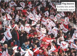  ??  ?? Flag bearers Scarlets fans at the La Rochelle match