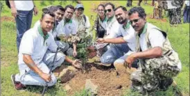  ?? RISHIKESH CHOUDHARY/HT ?? College students take part in the tree plantation drive at Varap village on Sunday.