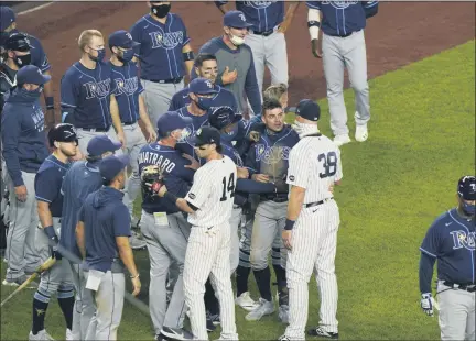 ?? KATHY WILLENS — ASSOCIATED PRESS FILE ?? Tampa Bay Rays and New York Yankees players and coaches exchange words after the Yankees’ 5-3win in New York on Tuesday, Sept. 1. Both teams’ benches received warnings from the umpires after Yankees relief pitcher Aroldis Chapman threw near the head of pinch-hitter Michael Brosseau in the ninth inning.