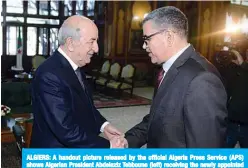  ?? —AFP ?? ALGIERS: A handout picture released by the official Algeria Press Service (APS) shows Algerian President Abdelaziz Tebboune (left) receiving the newly appointed Prime Minister Abdelaziz Djerad in the capital Algiers on Saturday.