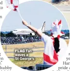  ??  ?? FLAG Fan waves a St George’s