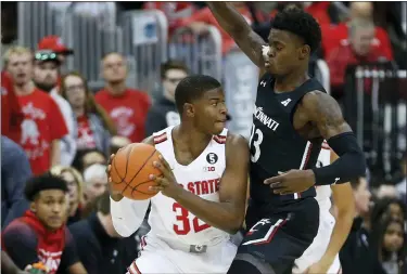  ?? JAY LAPRETE — THE ASSOCIATED PRESS ?? Ohio State’s E.J. Liddell, left, looks for an open pass as Cincinnati’s Tre Scott defends during the first half Nov. 6.
