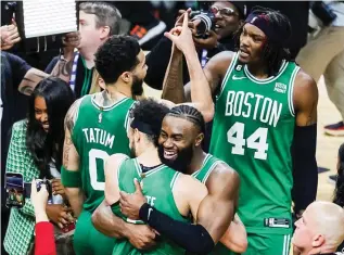  ?? (AFP) ?? THE BOSTON CELTICS celebrate their dramatic Game 6 win with Derrick White sinking a buzzer-beating putback against the Miami Heat.