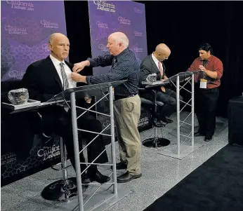  ?? Rich Pedroncell­i / Associated Press ?? Gov. Jerry Brown (left) and Republican challenger Neel Kashkari (third from left) prepare for their gubernator­ial debate in Sacramento on Sept. 4.