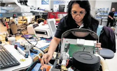  ?? Melissa Phillip / Staff photograph­er ?? Raquel Jordan, a biomedical tech, works on equipment at US Med-Equip. The company maintains the equipment so hospitals don’t incur added costs when renting.