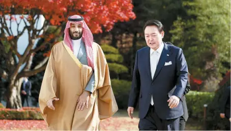  ?? Courtesy of South Korean presidenti­al office ?? President Yoon Suk-yeol and Saudi Arabian Crown Prince and Prime Minister Mohammed bin Salman take a walk after their meeting at the former’s residence in Seoul, Thursday.