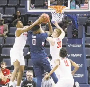  ?? Troy Glasgow / Associated Press ?? Houston’s Chris Harris Jr., Caleb Broodo and Nate Hinton fight for a rebound with UConn’s Eric Cobb during the AAC quarterfin­als on Friday in Memphis, Tenn. The top-seeded Cougars won 84-45.