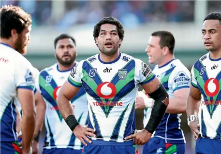  ?? GETTY IMAGES ?? Adam Blair and his Warriors team-mates look dejected during the hefty defeat to the Roosters.