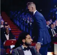  ?? BT SPORT ?? Cold shoulder: Salah keeps his cool as Ramos touches the left shoulder dislocated in Kiev