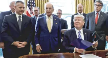  ?? — Reuters photo ?? President Trump smiles after announcing a permit for TransCanad­a Corp’s Keystone XL oil pipeline while TransCanad­a Chief Executive Officer Russell Girling (left) in the Oval Office of the White House in Washington, in March 2017.