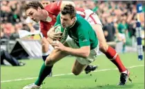  ??  ?? Ireland's Tommy Bowe (R) scores a try against Wales during the Six Nations internatio­nal rugby union match at the Aviva stadium in Dublin on February 5, 2012. AFP