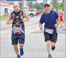  ?? KATHY JOHNSON PHOTO ?? Adam Casey, Elmsdale (#28) and Chris Nickerson, Cape Sable Island, cross the finish line for the Nova Scotia Marathon on July 22.