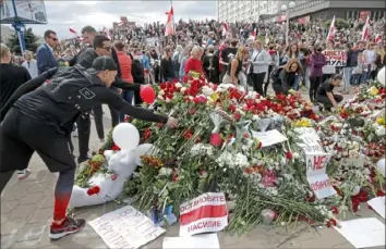  ?? Dmitri Lovetsky/Associated Press ?? People lay flowers Saturday where protester Alexander Taraikovsk­y, 34, died during a demonstrat­ion Monday against the Belarusian presidenti­al election results in Minsk, Belarus.