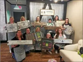  ?? SUBMITTED PHOTO ?? Employees of AR Workshop in New Hanover pose with some of their own creations. The staff recently held a training to prepare for the May 19 opening of the studio.