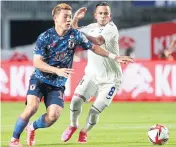  ?? AFP ?? Japan’s Ritsu Doan, left, in action against Honduras in a friendly game this month.