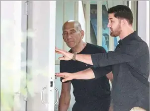  ?? JACK GUEZ/AFP ?? Former Israeli Prime Minister Ehud Olmert (left), 71, leaves the Maasyahu prison, yesterday, in Ramla.
