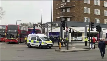  ?? ASSOCIATED PRESS ?? Police attend the scene after an incident in Streatham, London, Sunday. London police say officers shot a man during a “terrorism-related incident” that involved the stabbings of “a number of people.”