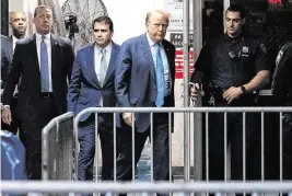  ?? MICHAEL M. SANTIAGO TNS ?? Former President Donald Trump returns to the courtroom Friday after a break in his trial for allegedly covering up hush money payments linked to extramarit­al affairs.