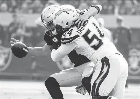  ?? Robert Gauthier Los Angeles Times ?? MELVIN INGRAM of the Chargers sacks Oakland quarterbac­k Derek Carr and forces a fumble in the second quarter Sunday.