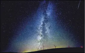  ?? MIcHAEL LOPEZ /AP PHOTO ?? The Milky Way lights up the Pacific Northwest sky during the Perseid Meteor Shower in August 2016 near windmills north of Dayton, Wash.