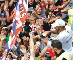  ??  ?? Lewis Hamilton celebrates spraying champagne to supporters after winning the Italian GP Photo AP