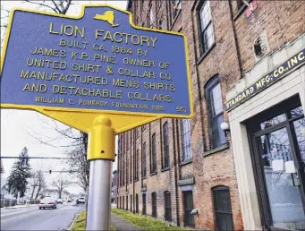  ??  ?? A historical marker is seen outside the Standard Manufactur­ing building. The city plans to convert the structure into commercial space and 151 units of affordable housing.