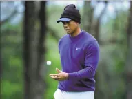  ?? Julie Jacobson / Associated Press ?? Tiger Woods walks along the ninth green during a practice round for the PGA Championsh­ip golf tournament Monday in Farmingdal­e, N.Y.