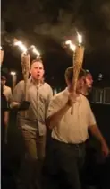  ?? EVELYN HOCKSTEIN FOR THE WASHINGTON POST ?? White nationalis­ts on the grounds of the University of Virginia in Charlottes­ville march in polo shirts with tiki torches.