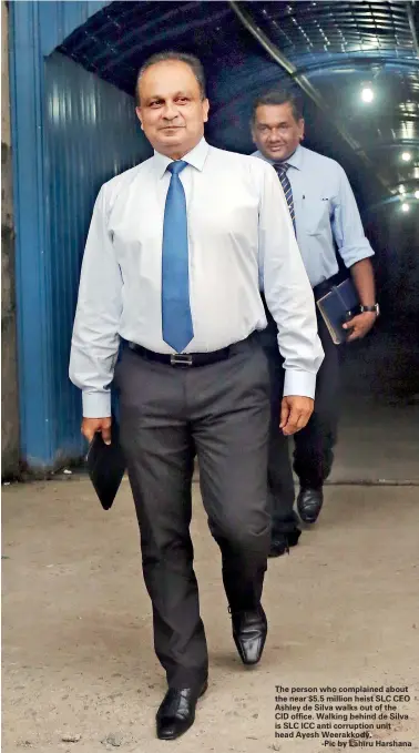  ??  ?? The person who complained about the near $5.5 million heist SLC CEO Ashley de Silva walks out of the CID office. Walking behind de Silva is SLC ICC anti corruption unit head Ayesh Weerakkody.-Pic by Lahiru Harshana