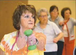  ??  ?? Sandi Smelko, 69, of Carnegie, takes part in an exercise class for seniors at the center.