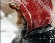  ?? JOSH GALEMORE — THE CASPER STAR-TRIBUNE VIA AP ?? Joe Miller’s beard freezes over as he walks through downtown Casper, Wyo., during a winter storm Wednesday. The storm brought blizzard conditions to parts of Colorado, Wyoming, Montana, Nebraska and South Dakota.