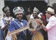  ?? AP PHOTO/BRUNA PRADO ?? Carnival King Momo, Wilson Dias da Costa Neto, holds the key of the city as the Rio de Janeiro Mayor Eduardo Paes (right) applauds during a ceremony marking the official start of Carnival in Rio de Janeiro, Brazil, on Wednesday.