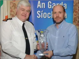  ??  ?? Paul Bradley, receiving a Special Achievemen­t Award for his son Steven, from Chief Superinten­dent Con Cadogan.