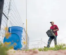  ?? GREGORY BULL/AP ?? Migrant rights activist Eduardo Canales carries jugs of water to a water drop this month in Falfurrias, Texas. The water is for migrants who enter the region.