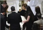  ?? TODD MCINTURF — DETROIT NEWS VIA AP ?? Family members, including mother Mary “Mia” Fraser, center right, place the pall on the casket of Brian Fraser as family members, friends and supporters gather during the funeral mass for Brian Fraser at St. Paul on the
Lake Catholic Church in Grosse Pointe Farms, Mich., on Saturday.